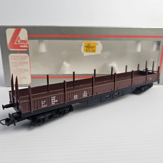 Lima 309042 DB HO scale four-axle brown stake wagon, three-quarter view.