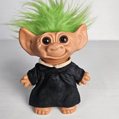 Vintage Uneeda Doll Co. troll doll with bright green hair, black dress, and large ears, approximately 23cm tall, pre-owned collectible.