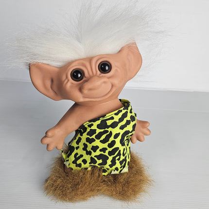 Vintage Uneeda Doll Co. troll doll with white hair, caveman-style outfit and faux fur trim, approximately 23cm tall, pre-owned collectible.
