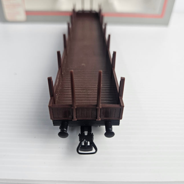 End view of Lima 309042 DB HO scale stake wagon with coupling and upright stakes.