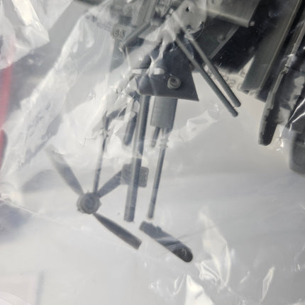 Close-up of damaged propeller and detached parts inside Airfix Fairey Rotodyne kit