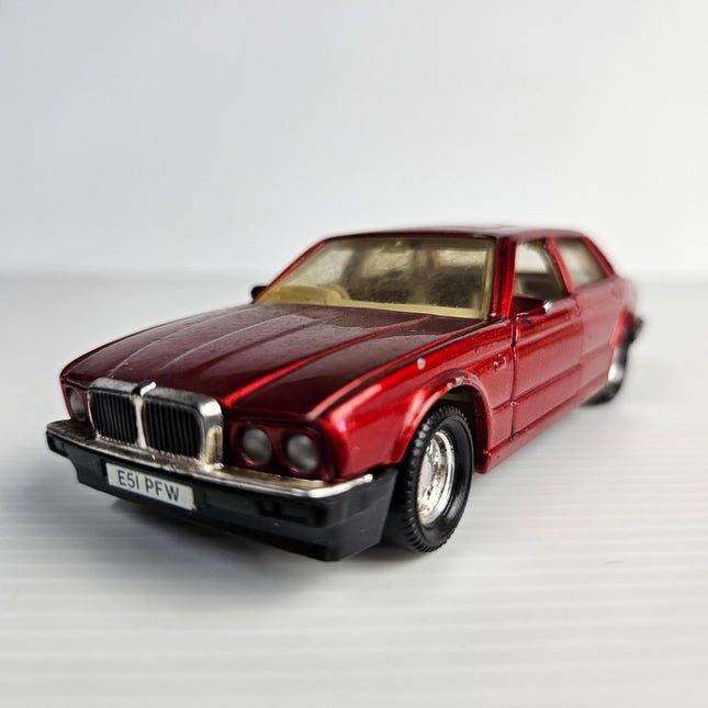Front three-quarter view of metallic red Matchbox SuperKings Jaguar XJ6 XJ40