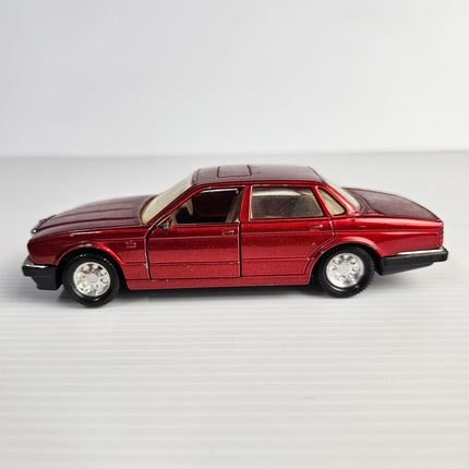 Side view of Matchbox SuperKings K-146 metallic red Jaguar XJ6 XJ40 diecast model 2